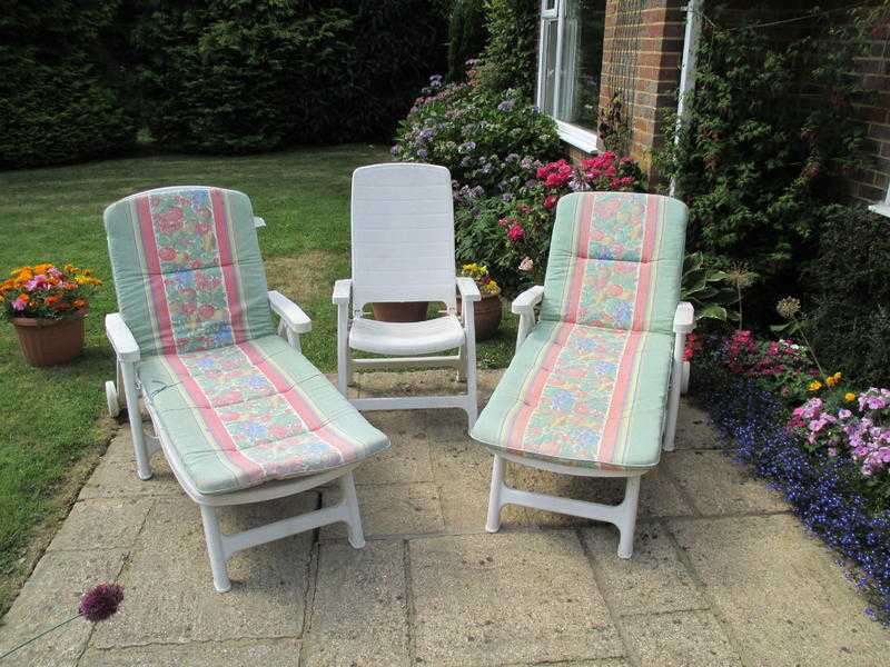 2 Plastic garden loungers, with cushions  1 matching chair without cushion