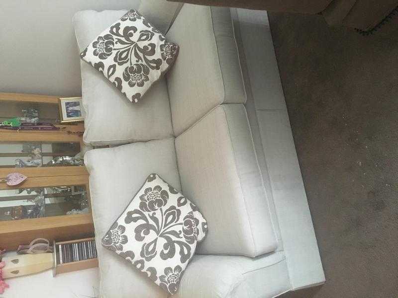 2 seater cream fabric sofa.