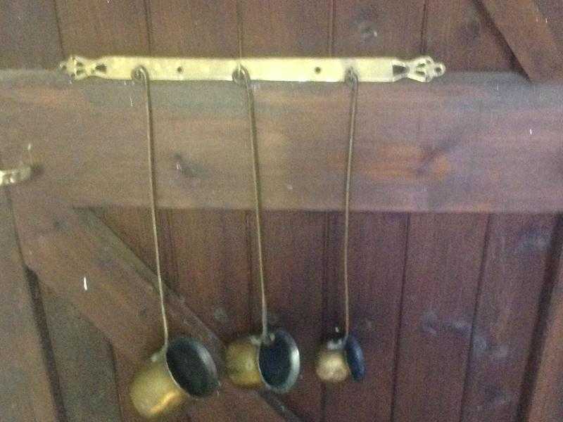 3 brass ornamental spirit measures with brass hanging rack