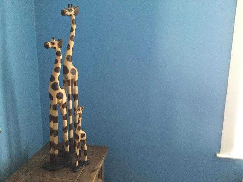 3 wooden giraffes