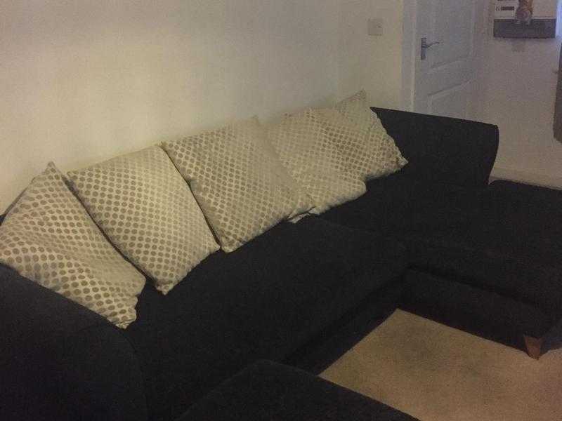 4 seater black pillow back lounger sofa and Footstall