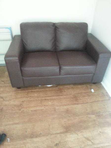 A 2 seater leather type material sofa