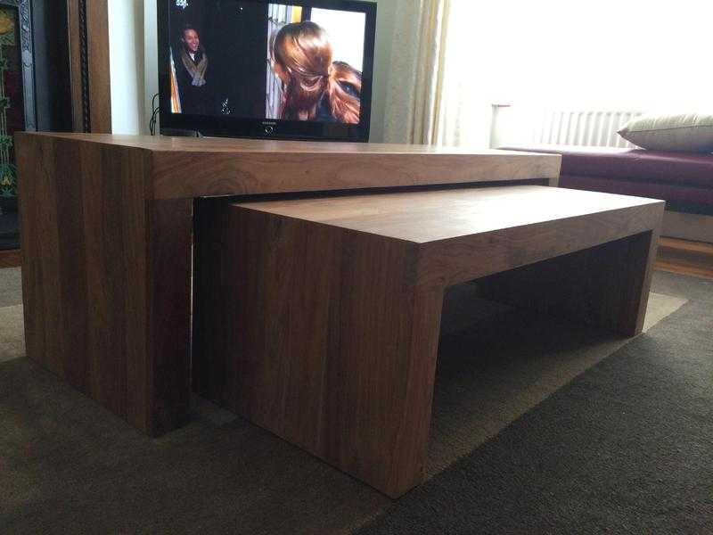 A nest of sheeshen wood coffee tables