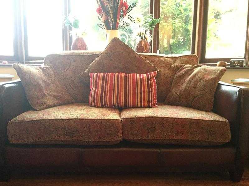 A pair of 2 seater burgundy leather and fabric sofa