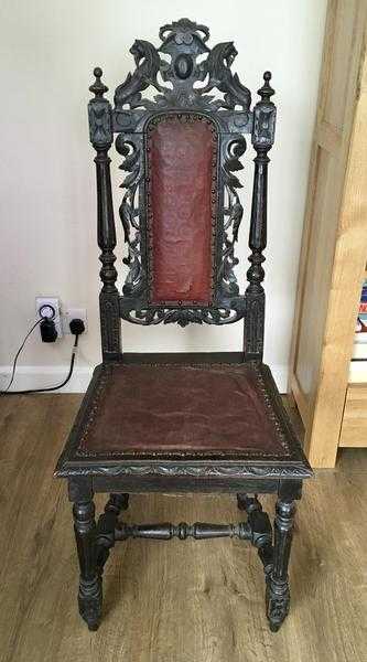 Antique carved wood and leather chair.