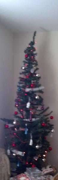 Artificial approx 7 tall green xmas tree in used condition, but very serviceable to use n and on