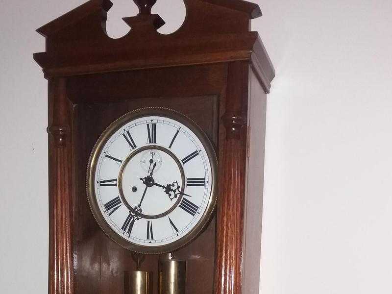 ATTRACTIVE TWIN WEIGHT PENDULUM DRIVEN ANTIQUE WALL CLOCK CIRCA 1900.GOOD WORKING ORDER.