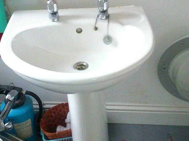 Bathroom sink with pedestal and taps