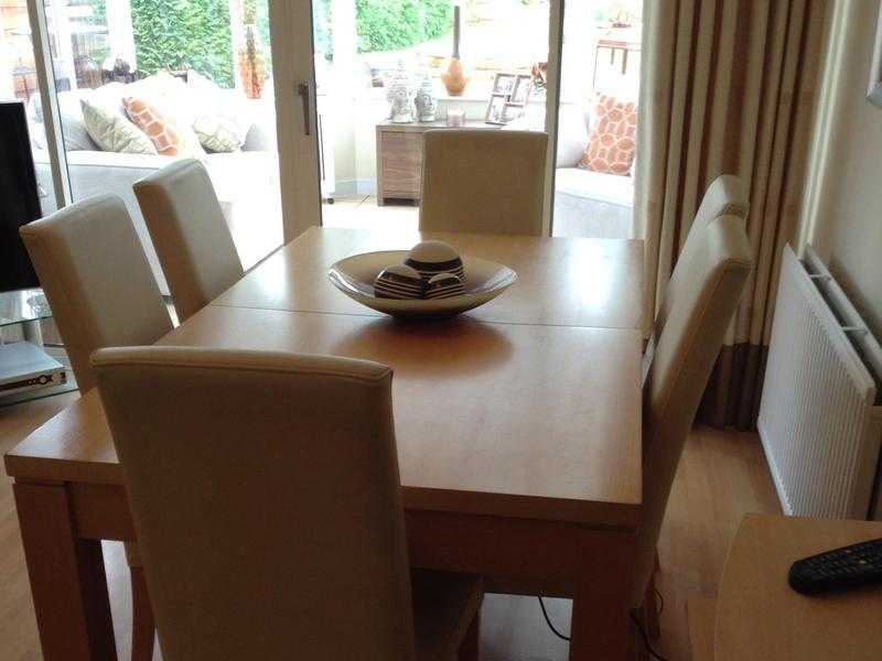 Beech dining table and  6 cream faux leather chairs