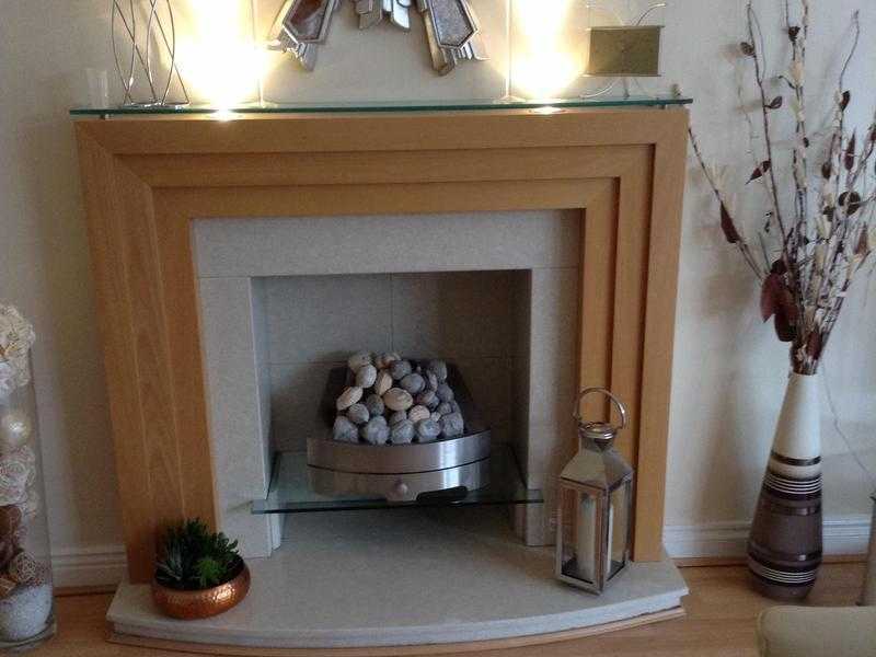 Beech fireplace with marble back and hearth and chrome gas fire with pebbles. Very