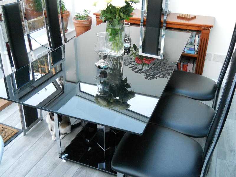 BLACK GLASS DINING TABLE AND SIX CHAIRS