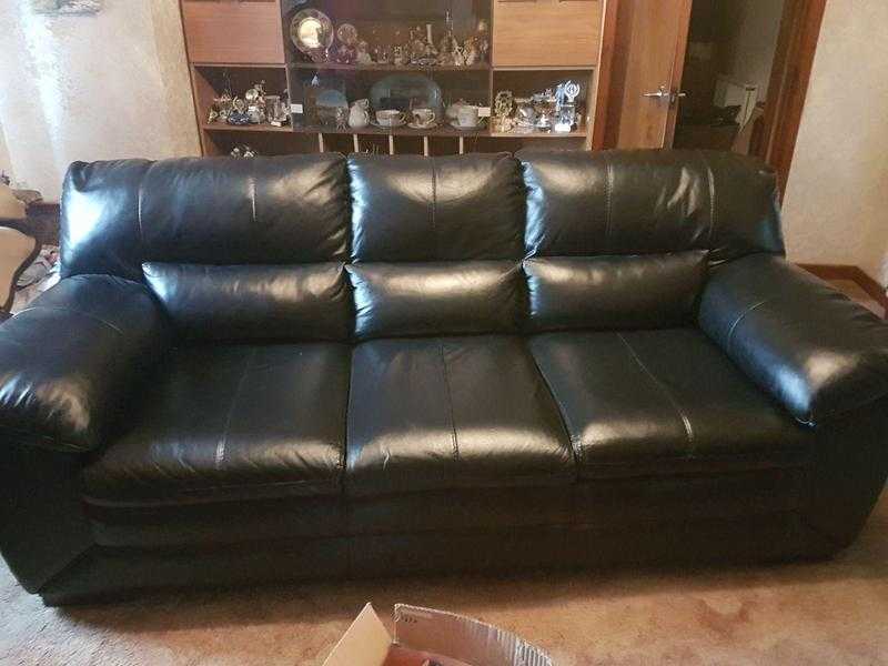 Black leather sofa, brown recliner sofa and old vintage chair.