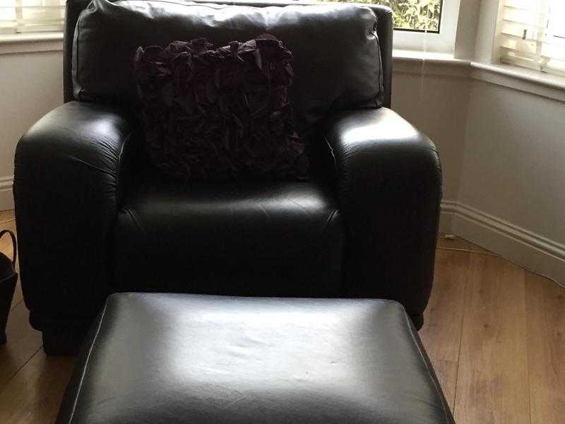 Brown leather armchair and matching footstool for sale