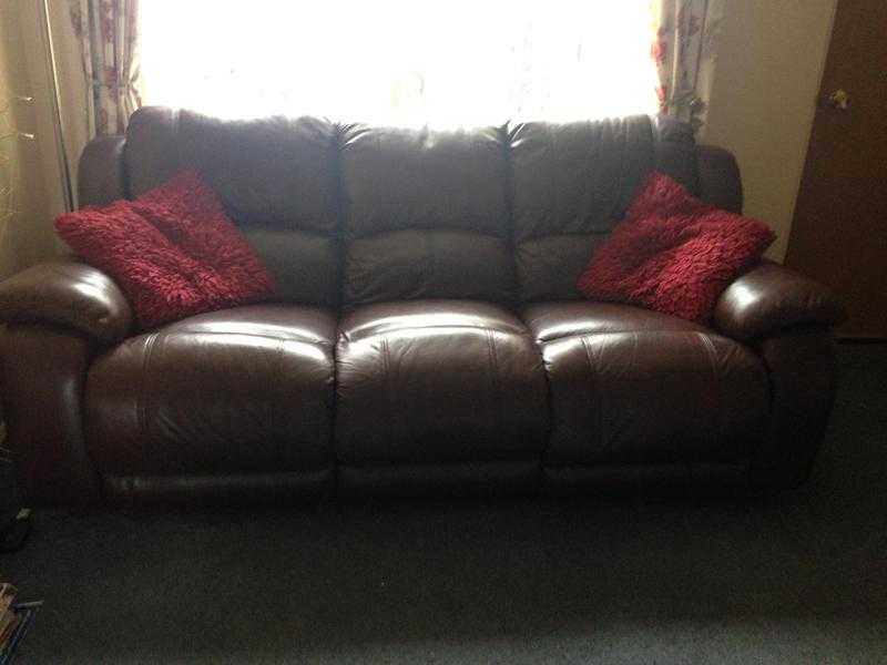 Brown leather recliner settee.