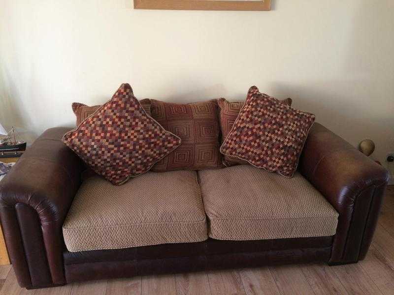 Brown leather sofa with material seats.