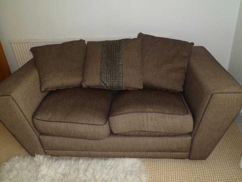 Brown sofa with reversible cushions.