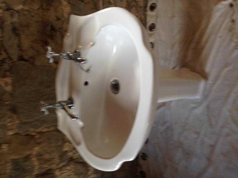 Ceramic pedestal basin with taps in as new condition