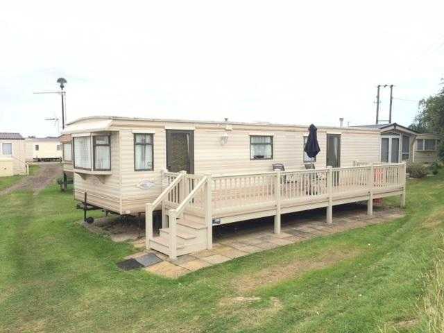 cheap caravan with large decking, sited in norfolk at heacham beach, park resorts.