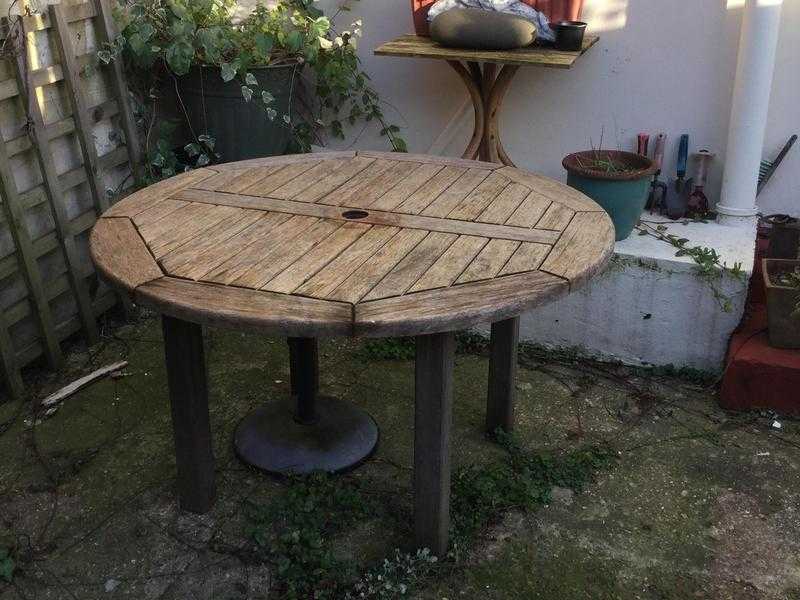 Circular wooden garden table and umbrella stand