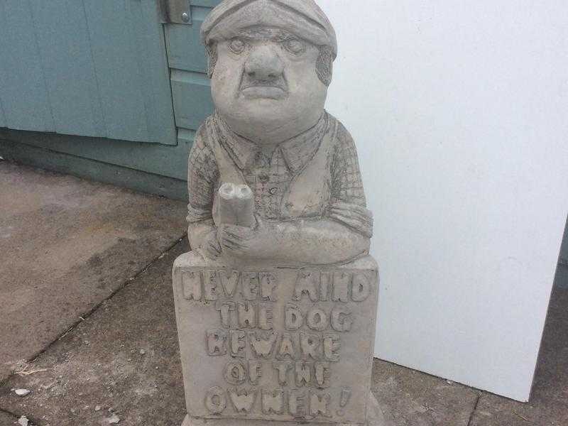 Concrete garden ornament man with sign