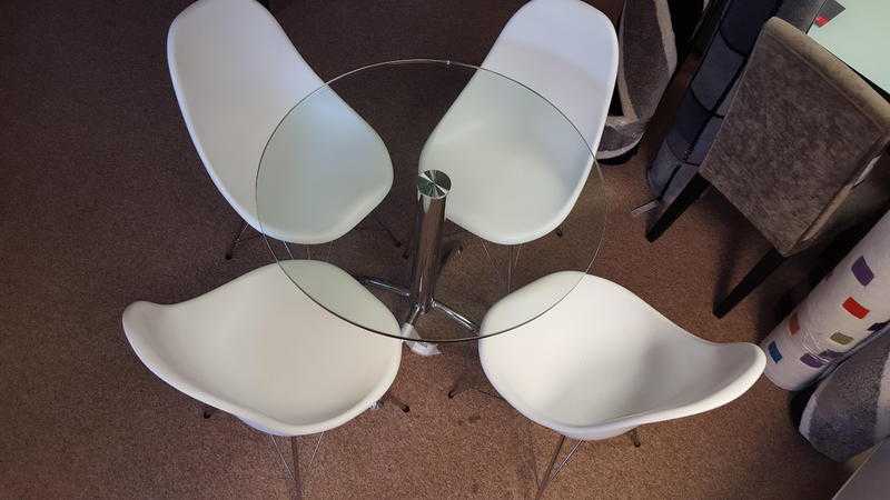 Contemporary Glass circular dining table with Eiffel white chairs