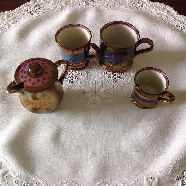 Copper lustre 3 cups, different sizes, one small jug with lid.