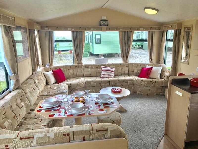 Cracking starter caravan with double glazing, central heating and decking to the side