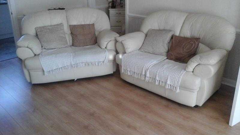 cream leather settees and foot stool