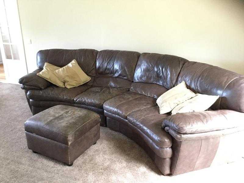 curved brown leather 4 seating sofa with matching poofstorage box.