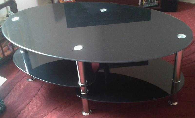 Darkened Glass, Oval Coffee Table with 2 leaf shaped shelves under large main one .