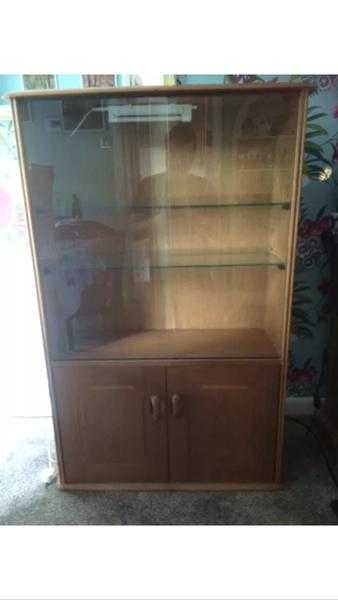 Display cabinet with sliding glass doors, glass shelves down light and cupboard.