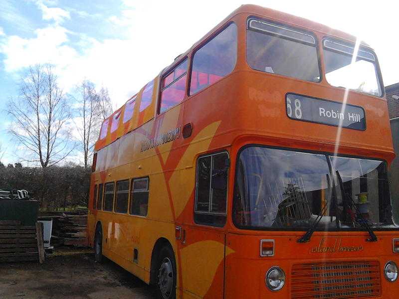 Double Decker bus with a semi open top fitted with a tailor made marine canopy