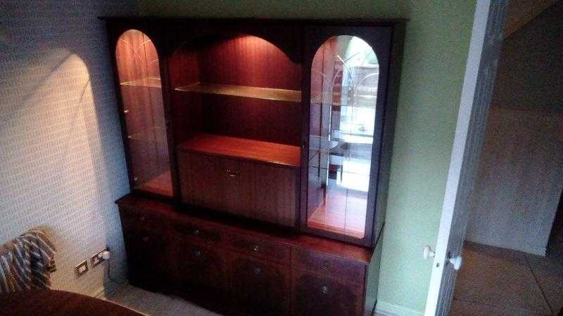 Dresser comprising a glass fronted cabinet on top of a sideboard