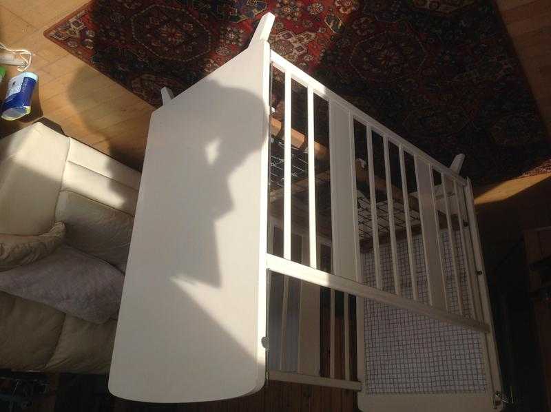 Drop sided wooden cot