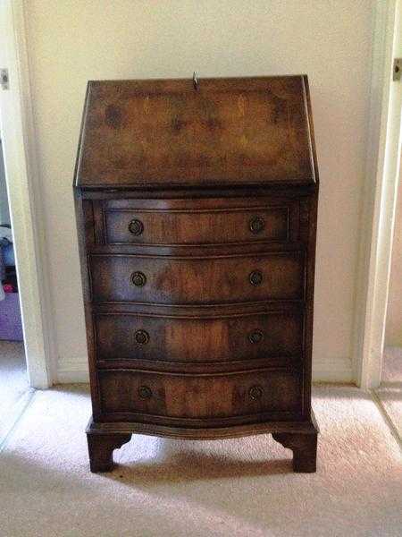 Edwardian mahogany bureau with four serpentine drawers.