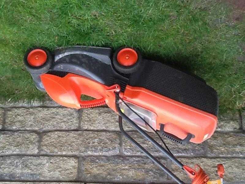 Electric lawnmower and two strimmers