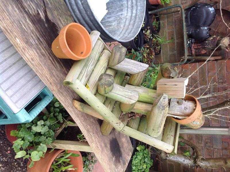 Garden ornament, flower pot man reclining on lounger