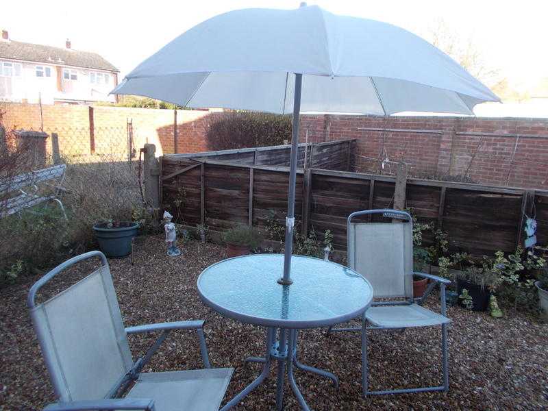 Garden table and chairs  parasol.