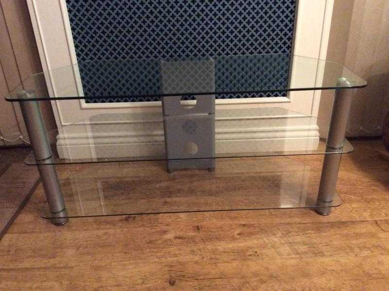 Glass corner tv stand with stainless steel legs.