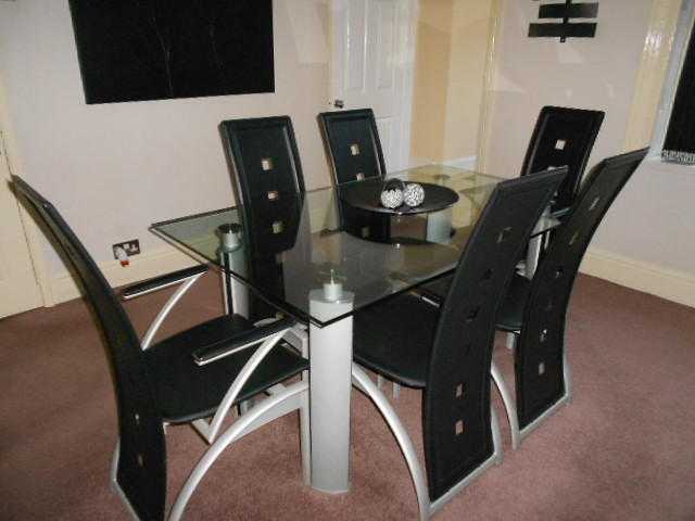 Glass Dining Table and 6 chairs including 2 carvers.