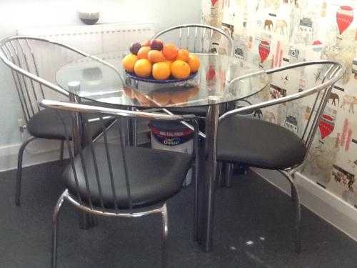 Glass table and 4 chrome and black chairs