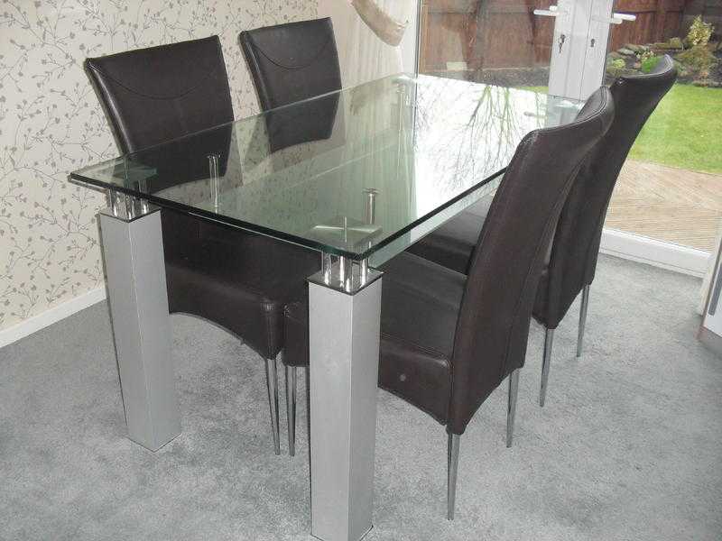 glass table .and four chairs .