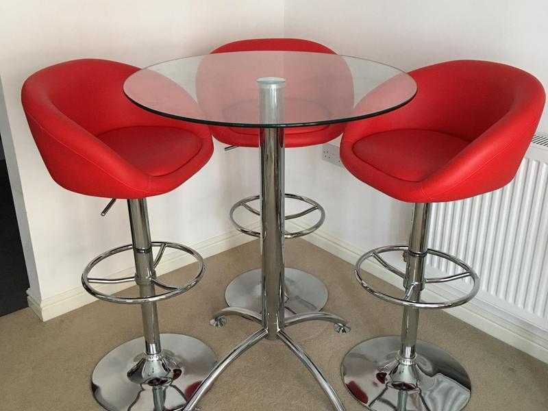 Glass table with three bar stools