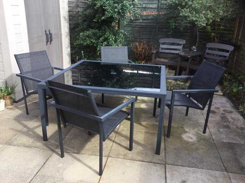 Glass top garden table and four chairs