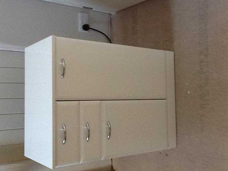 Gloss white bathroom storage unit with drawers