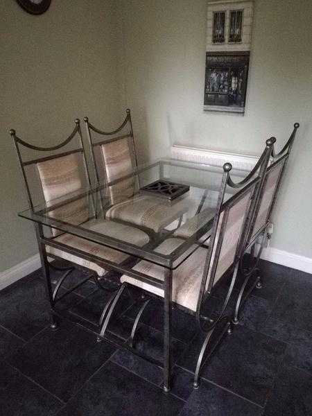 Good quality heavy glass top and solid iron table and chairs (Leekes)-  excellent condition.