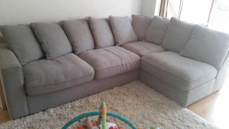 Grey corner sofa including footstall