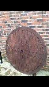 Hard wood circular garden table and four chairs