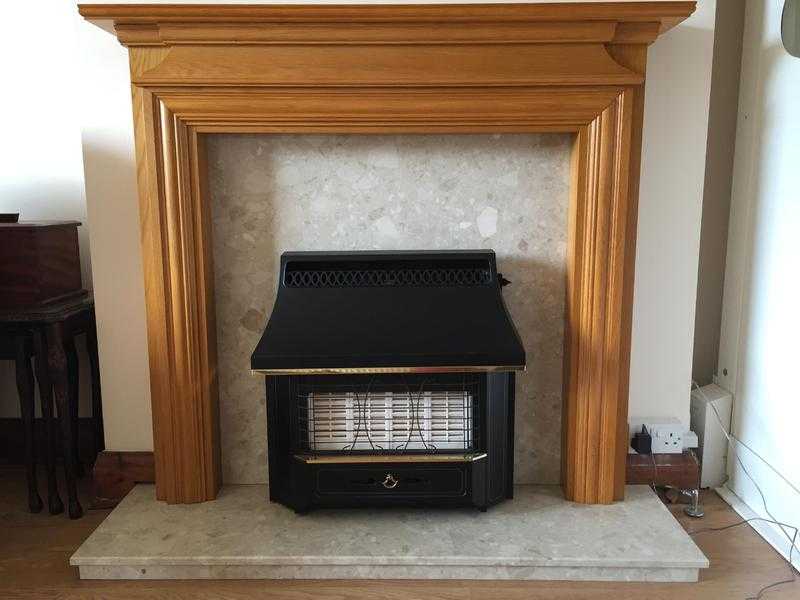 Honey Pine Surround. Cream marble hearth and gas fire