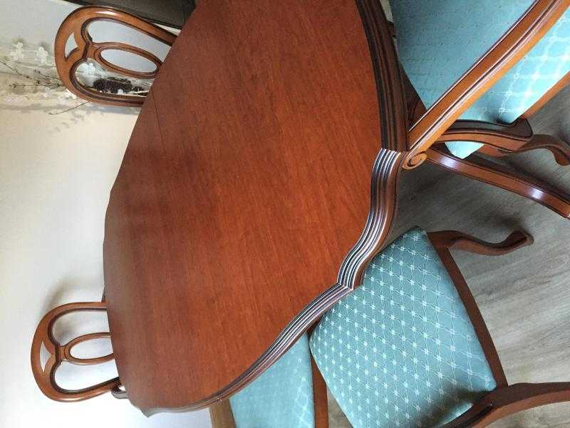 John Coyle Dinning Room table and 6 chairs . Yew wood sold pedestal table in excellent condition .